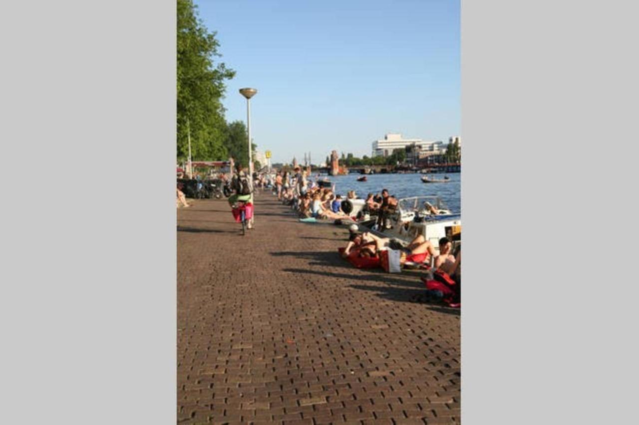 Tiny Houseboat On The Amstel River Amsterdam